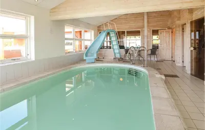 a swimming pool with a slide in a house at Awesome Home In Spøttrup With Sauna in Spottrup