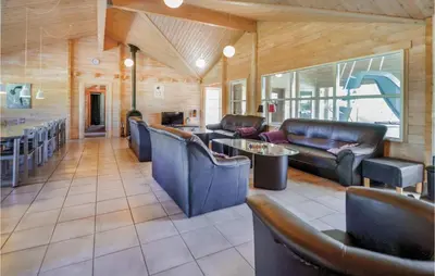a living room with leather furniture and a bar at Awesome Home In Spøttrup With Sauna in Spottrup