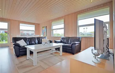 a living room with a couch and a table at Holiday Home Strandlyst Vinderup Vi in Vinderup
