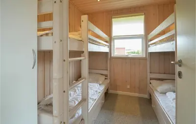 a room with four bunk beds and a window at Holiday Home Strandlyst Vinderup Vi in Vinderup