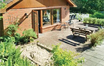 a patio with a picnic table and a bench at Awesome Home In Spøttrup With Wifi in Spottrup