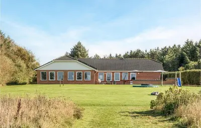 a house with a large lawn in front of it at Stunning Home In Spøttrup With Sauna in Spottrup