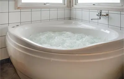 a bath tub filled with water in a bathroom at Holiday Home Skovstjernevej Lemvig Ii in Lemvig