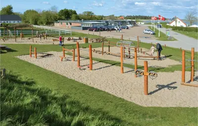 a playground with play equipment in a park at Holiday Home Skovstjernevej Lemvig Ii in Lemvig
