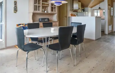 a dining room table and chairs in a kitchen at Holiday Home Skovstjernevej Lemvig Ii in Lemvig