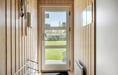 a door with a window in a hallway at Holiday Home Sommerstedvej Denm in Vinderup