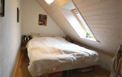 a small bedroom with a bed in a attic at Apartment Lysenvej in Roslev