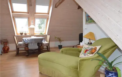a living room with a green couch and a table at Apartment Lysenvej in Roslev