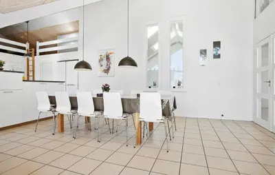 a kitchen with a dining room table and chairs at Amazing Home In Vinderup With Sauna in Vinderup