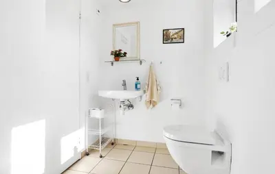 a white bathroom with a toilet and a sink at Amazing Home In Vinderup With Sauna in Vinderup