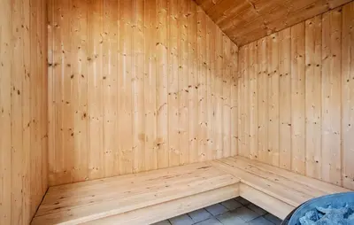 a wooden sauna with a wood paneled wall at Amazing Home In Vinderup With Sauna in Vinderup