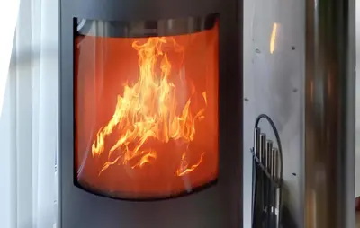 a fire inside a container with flames in it at Holiday Home Lerskrænten Vinderup I in Vinderup