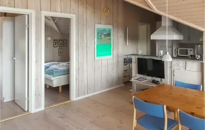 a room with a dining table and a bedroom at Holiday Home Lerskrænten Vinderup I in Vinderup
