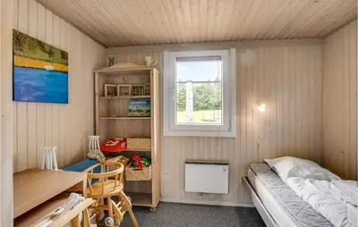 a small room with a bed and a desk and a window at Holiday Home Skibstedvej Hurup Thy in Sønder Ydby