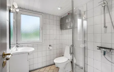 a bathroom with a toilet and a sink and a shower at Holiday Home Skibstedvej Hurup Thy in Sønder Ydby
