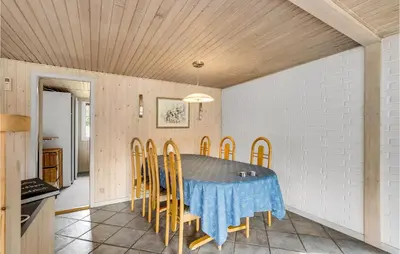 a dining room with a table and chairs at Holiday Home Skibstedvej Hurup Thy in Sønder Ydby