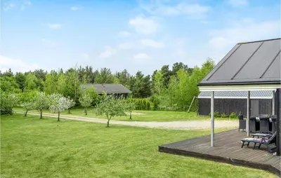 a backyard with a deck and a gazebo at Holiday Home Skovvej Thyholm Xii in Thyholm