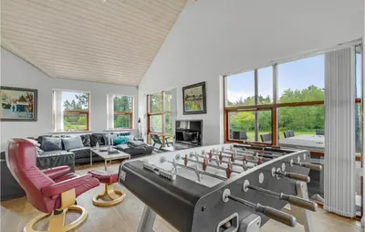 a living room with a large ping pong table at Holiday Home Skovvej Thyholm Xii in Thyholm