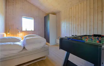 a room with a bed and a pool table at Holiday Home Kalkstensvej in Spottrup