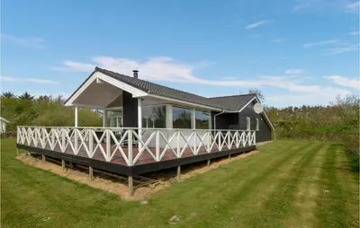 a house with a large lawn in front of it at Holiday Home Kalkstensvej in Spottrup