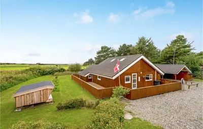 a home with a large yard with a house at Lovely Home In Thyholm With Sauna in Thyholm