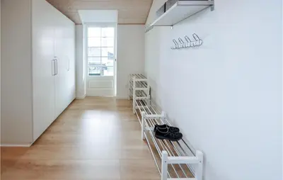 a hallway with white walls and wooden floors at Holiday Home Kildebakken Vinderup V in Vinderup