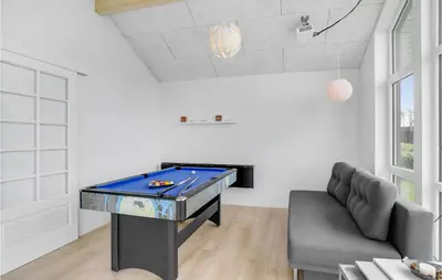 a ping pong table in a living room with a couch at Holiday Home Kildebakken Vinderup V in Vinderup