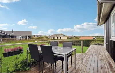 a patio with a table and chairs on a deck at Holiday Home Lerskrænten Vinderup Xi in Vinderup