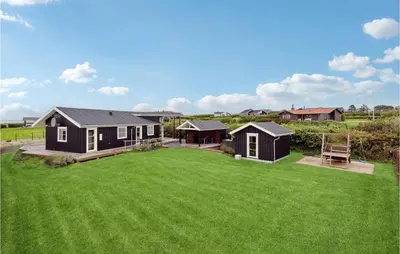 a house with a large yard with green grass at Holiday Home Lerskrænten Vinderup Xi in Vinderup