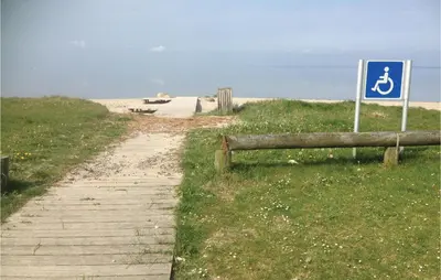 a path leading to a beach with a sign at Holiday Home Lærkevej Vinderup Xii in Vinderup
