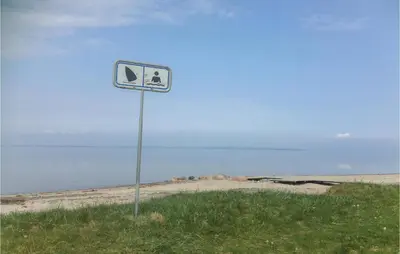 a sign on the side of a beach at Holiday Home Lærkevej Vinderup Xii in Vinderup