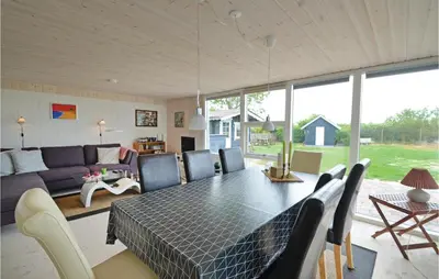 a living room with a table and a couch at Holiday Home Lærkevej Vinderup Xii in Vinderup
