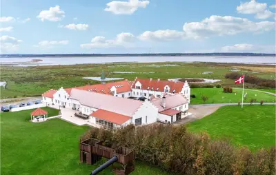 an aerial view of a large white house with red roofs at Bakkegården in Vesløs