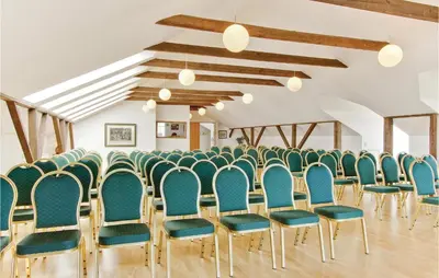 a row of chairs in a room with blue chairs at Bakkegården in Vesløs