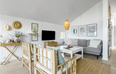 a living room with a couch and a tv at Holiday Home Ballesvej in Øster Assels