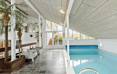 a swimming pool in a building with a swimming pool at Stunning Home In Roslev With Sauna in Roslev