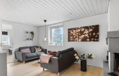 a living room with a couch and a chair at Stunning Home In Roslev With Sauna in Roslev