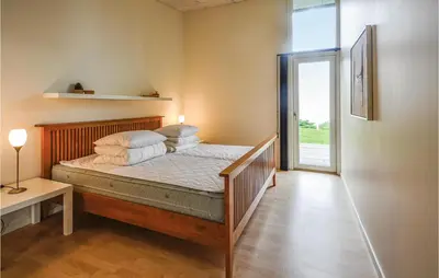 a bedroom with a bed with pillows on it at Holiday Home Følvigvej Roslev I in Roslev