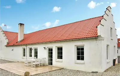 a white house with a red roof and a patio at Holiday Home Bakkegårdsvej in Vesløs