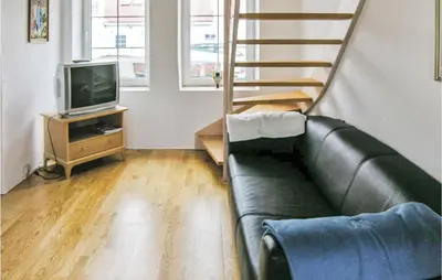 a living room with a couch and a television at Holiday Home Bakkegårdsvej in Vesløs