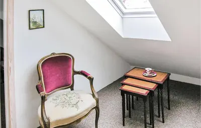 a room with a chair and a small table at Holiday Home Bakkegårdsvej in Vesløs