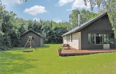 a small cabin with a deck and a camera at Holiday Home Kraghøjvej Nykøbing M Ix in Hesselbjerg