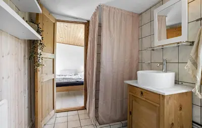 a bathroom with a sink and a shower at Holiday Home Pinen Roslev X in Roslev