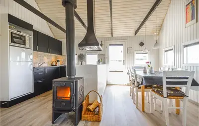 a kitchen and dining room with a stove in a room at Nice Home In Thisted With Kitchen in Thisted