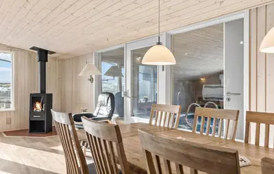 a dining room with a table and a fireplace at Gorgeous Home In Thisted With Sauna in Thisted