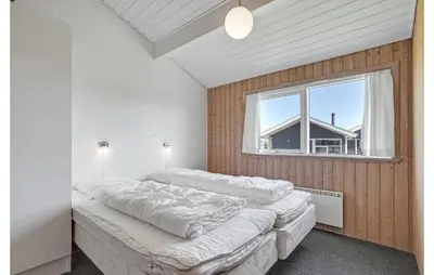a bedroom with two beds and a window at Stunning Home In Thisted With Sauna in Klitmøller