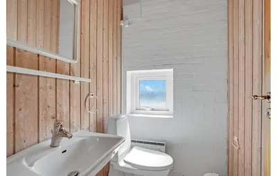 a bathroom with a white toilet and a sink at Stunning Home In Thisted With Sauna in Klitmøller