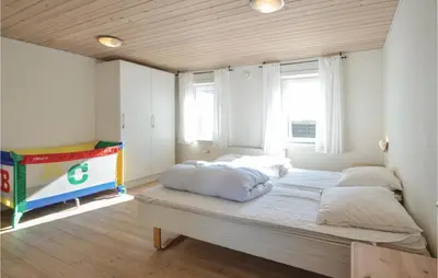 a bedroom with a large bed with two pillows on it at Holiday Home Glombak in Vesløs