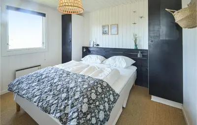 a bedroom with a large bed with a black headboard at Holiday Home Johnsvej Thisted V in Thisted