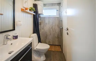 a bathroom with a toilet and a sink and a shower at Holiday Home Johnsvej Thisted V in Thisted